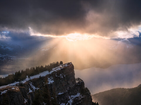 Person Standing On Mountain Peak In The Distance