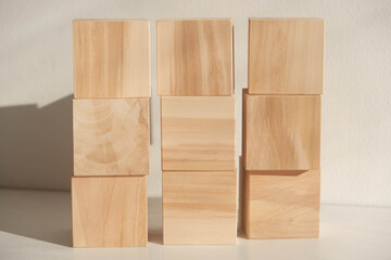 Wooden cubes from natural wood on a white background. Copy, empty space for text