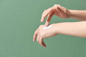 Female applying moisturizer to her Hands after bath.Skincare concept