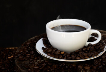 Coffee cups, coffee beans and cannabis leaves on black background The concept of drinking coffee...