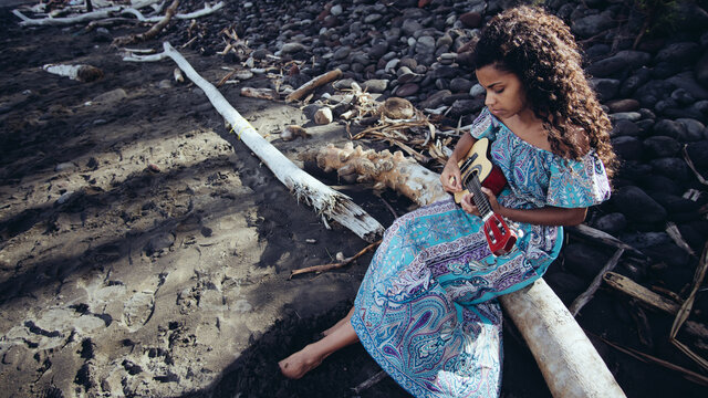 Woman at the beach with ukulele