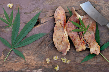 Roast Beef with Hemp Leaves On a brown wood floor Cannabis herb cooking ideas Medically authorized