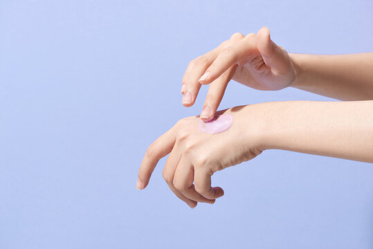 Woman Caring Hands With Cream Isolated On Purple