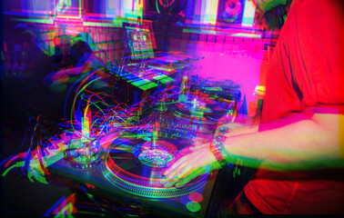 Hip hop dj scratches vinyl records on turntables on stage in nightclub.Professional party djs audio...