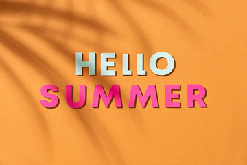 The word hello on craft paper with tropical background
