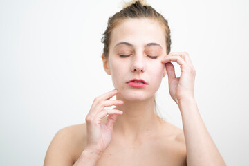 Fototapeta premium Happy Young Woman After Applying Cream on Her Face, Studio Shot on White Background