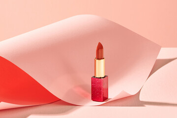 Lipstick still life on pastel background.