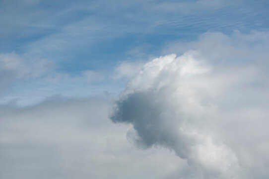 Blue sky and clouds nature photo with interesting cloud pattern and weather rolling in.