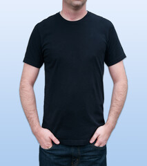 Guy black tshirt with model mockup with a front chest of a Caucasian man on a light blue background for copy space for custom text for fashion, clothing and apparel.