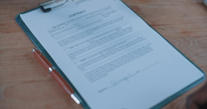 Close up of a busineswoman handing over a contract to a businessman 