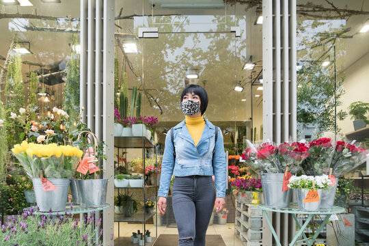 Woman Wearing Face Mask Near To Flower Shop