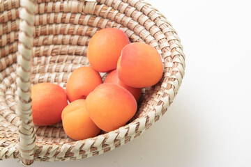 ripe apricots in plate on the table. Orange apricots fruits in bowl. Juicy apricots nutrition.