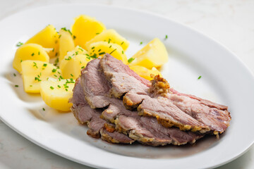 slowly roasted lamb on garlic with potatoes