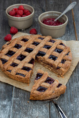 fresh baked linz cake with raspberries and almonds