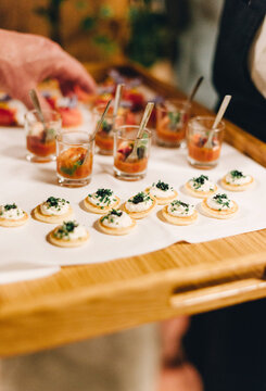 blini appetizers on a wooden server