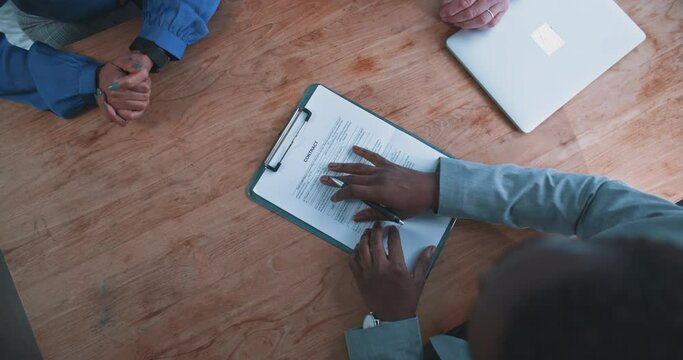 Close up of a busineswoman handing over a contract to a businessman 