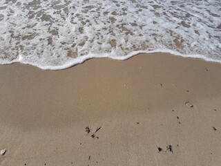 Sea waves run over the sandy shore