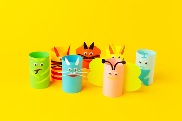 Fototapeta premium Handmade paper toys from toilet rolls, on yellow background.