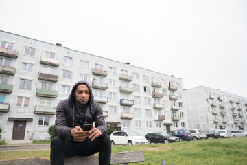 Man Using Cellphone In Front Of The Building