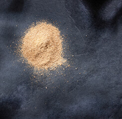 Maca powder in wooden spoon - Lepidium meyenii.