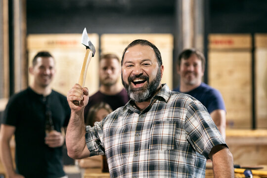Bearded Man Laughing While Throwing Axe