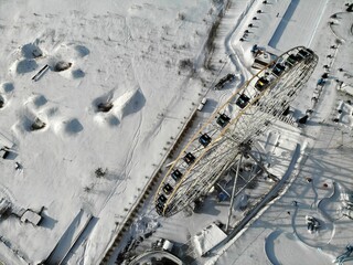 Ferris wheel in Tatarstan Kazan at winter Aerial view. Flying over. Top down