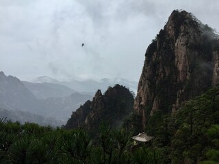 China Mount HuangShan - April, 2015: Natural scenery, sunsets, peculiarly-shaped granite peaks, Huangshan pine trees and views of the clouds from above. Photo taken in Yellow Mountain (UNESCO).