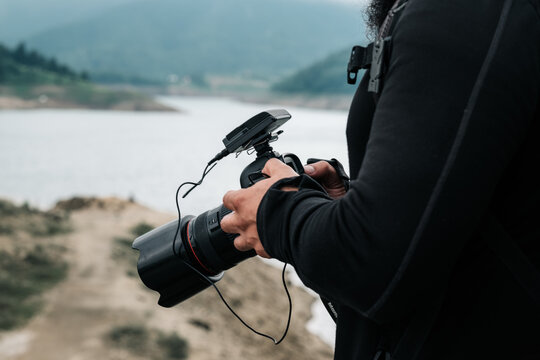 Anonymous Man Holding A Camera Outdoors