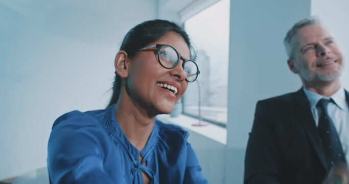 Indian female recruiter smiling while shaking hand with candidate