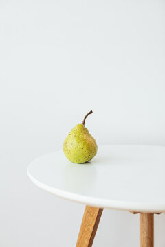 Still life of pear on white table