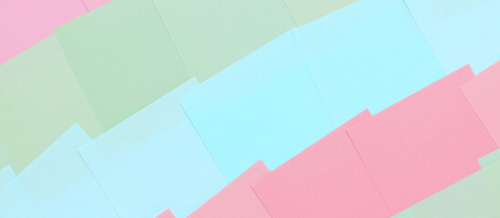 Abstract pastel background from colored note paper. Beautiful delicate background pink, green, blue. Banner