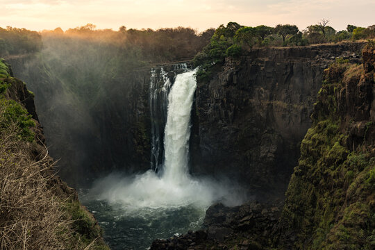 A Waterfall Framed by Lush Cliffs