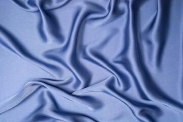 Blue silk or satin luxury fabric texture. Top view.
