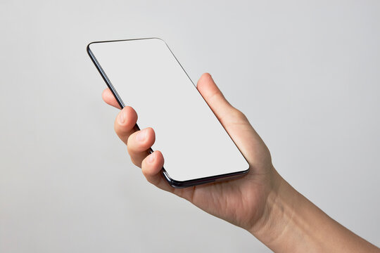 Woman Hand Holding Phone On White Background With Copy Space