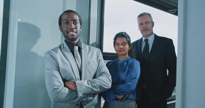 Multi-ethnic business people looking to the camera