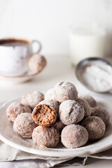 Homemade cottage cheese donuts balls with powdered sugar in a bowl on a light background. Beautiful breakfast. 