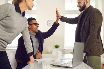 Team of young people choose winning strategy. Happy diverse business partners meeting in office,...