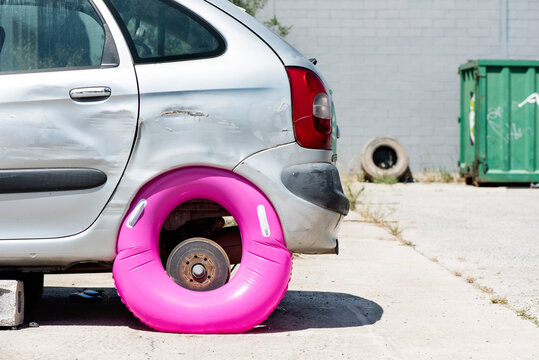 pink swim ring as a tyre in a car