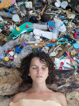 Woman portrait on plastic trash background