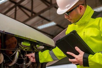 Technician fixing the engine of the airplane,Female aerospace engineering checking aircraft engines,Asian mechanic maintenance inspects plane engine