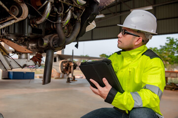 Technician fixing the engine of the airplane,Female aerospace engineering checking aircraft engines,Asian mechanic maintenance inspects plane engine