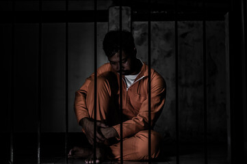 Asian man desperate at the iron prison,prisoner concept,thailand people,Hope to be free,Serious...