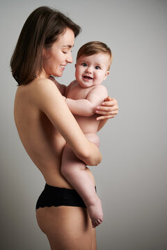 Naked mother with happy baby