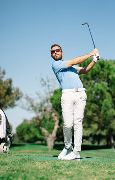 Man playing golf on summer day