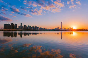 Fototapeta na wymiar sunset over the city or lake