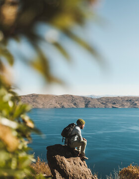 traveler sitting admiring the beauty of lake Titicaca