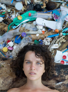 Woman portrait on plastic trash background