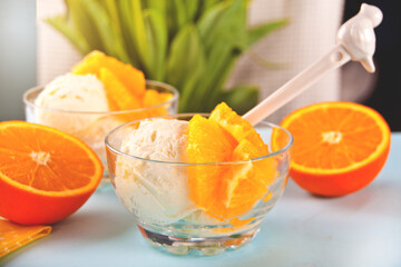 Homemade fresh orange ice cream with orange slices. Summer dessert.