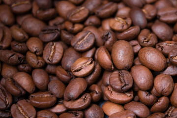 close up of Freshly roasted coffee beans background. top view