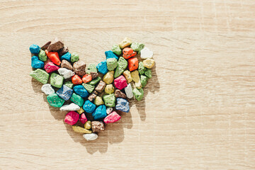 heart made of multi-colored stones on a light background